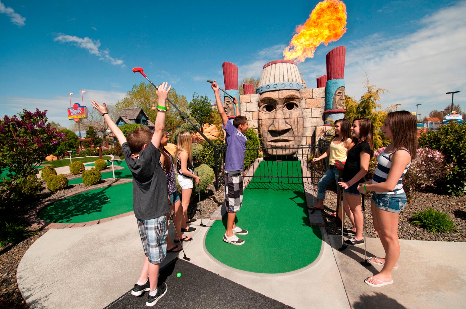 Kids cheer tiki fire on mini golf course