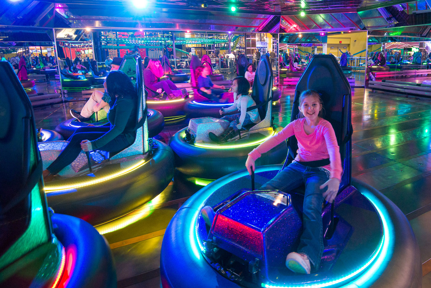 girl in pink shirt enjoys bumper cars