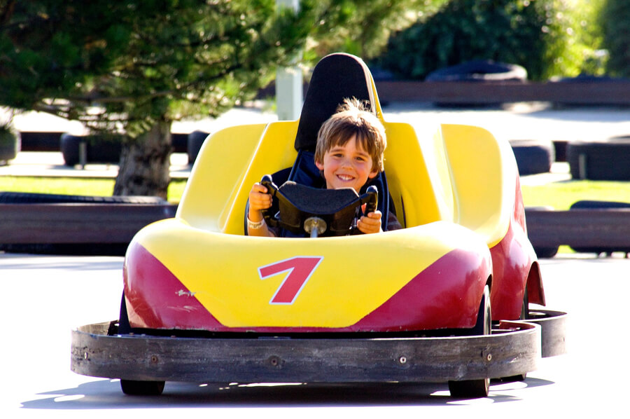 young boy driving go kart